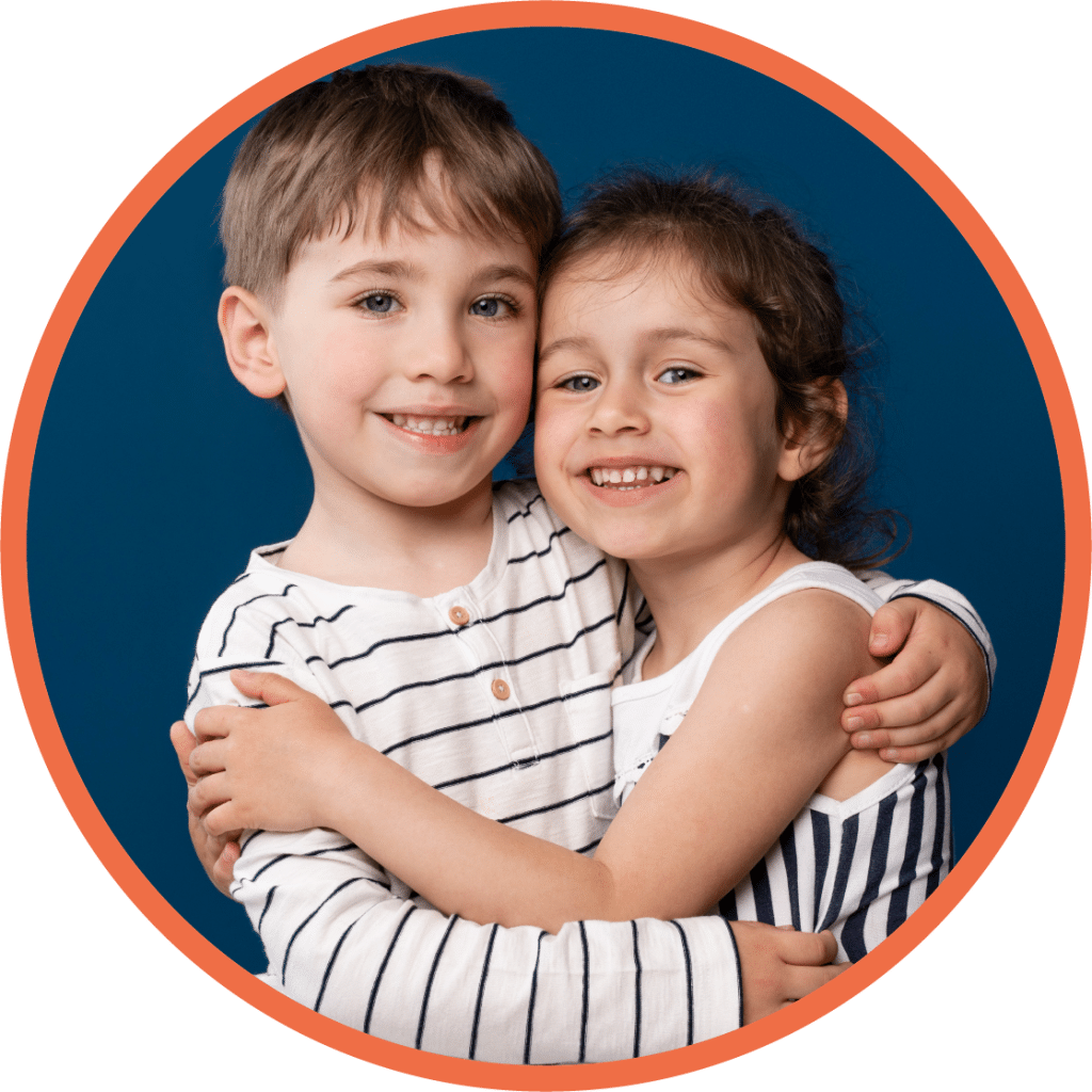 Boy and girl child hugging for picture